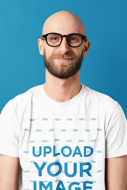 Mockup of a Bearded Man with Glasses Wearing a T-Shirt in a Studio