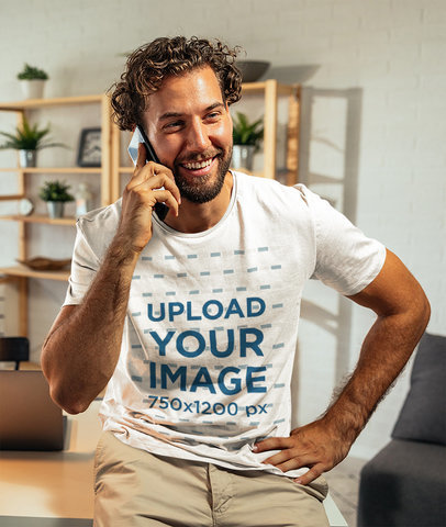 T-Shirt Mockup of a Man Making a Call in His Office