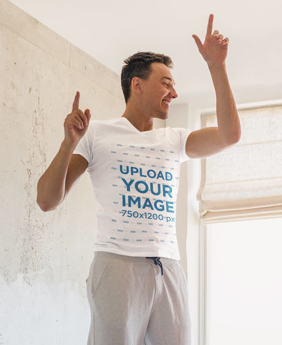 T-Shirt Mockup Featuring a Man Playfully Dancing in His Bedroom m2019-r-el2