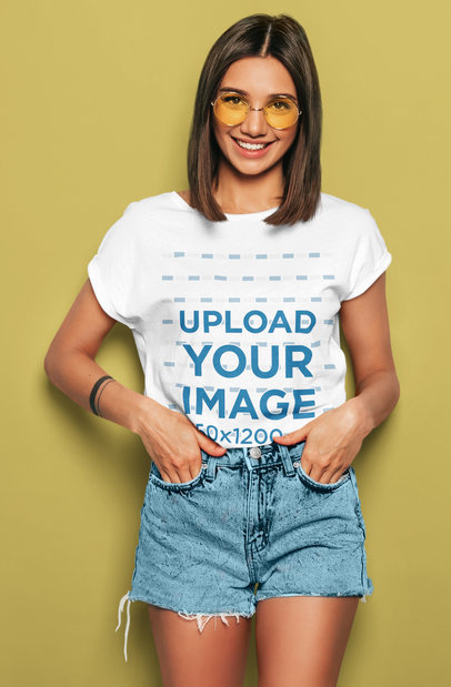 T-Shirt Mockup of a Young Woman Posing in a Studio with Her Hand in Her Pockets