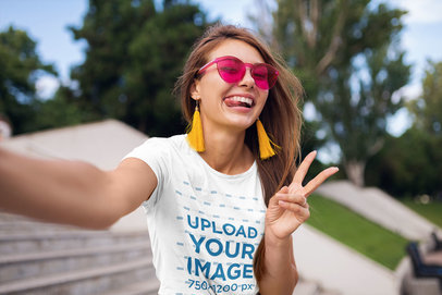 T-Shirt Mockup of a Woman with Trendy Sunglasses Taking a Selfie