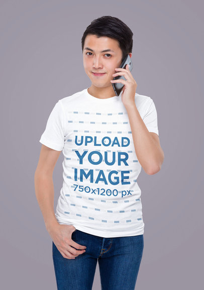 T-Shirt Mockup of a Man Posing in a Studio While Talking on the Phone