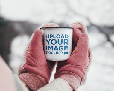 Mockup of a Woman Holding a 12 oz Enamel Mug in the Winter Time 