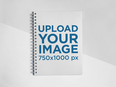 Frontal Shot Template of a Spiral Notebook Lying on a Bicolor Surface a15308