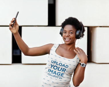 Sublimated Tank Top Mockup Featuring a Happy Woman with Headphones