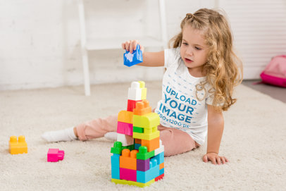 T-Shirt Mockup of a Little Girl Playing with Blocks