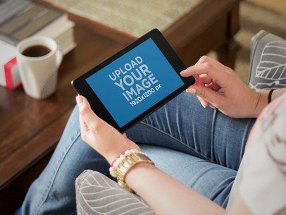 Mockup of a Woman Using a Nexus 7 in Landscape Mode at Home