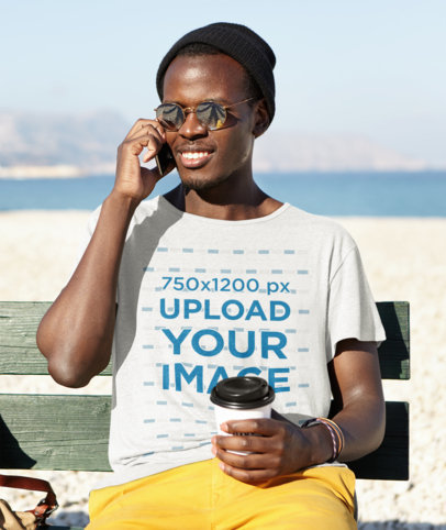 T-Shirt Mockup of a Man Waiting for Someone by the Beach