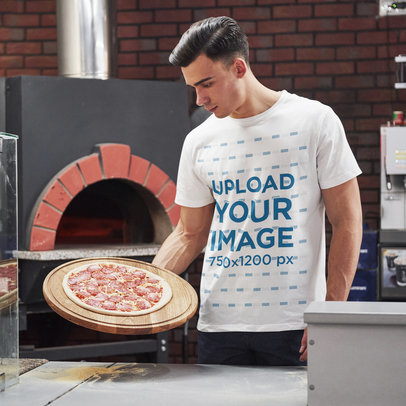 Basic T-Shirt Mockup of a Serious Man Holding a Pizza 