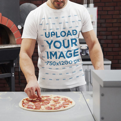 T-Shirt Mockup of a Muscular Man Making Pizza