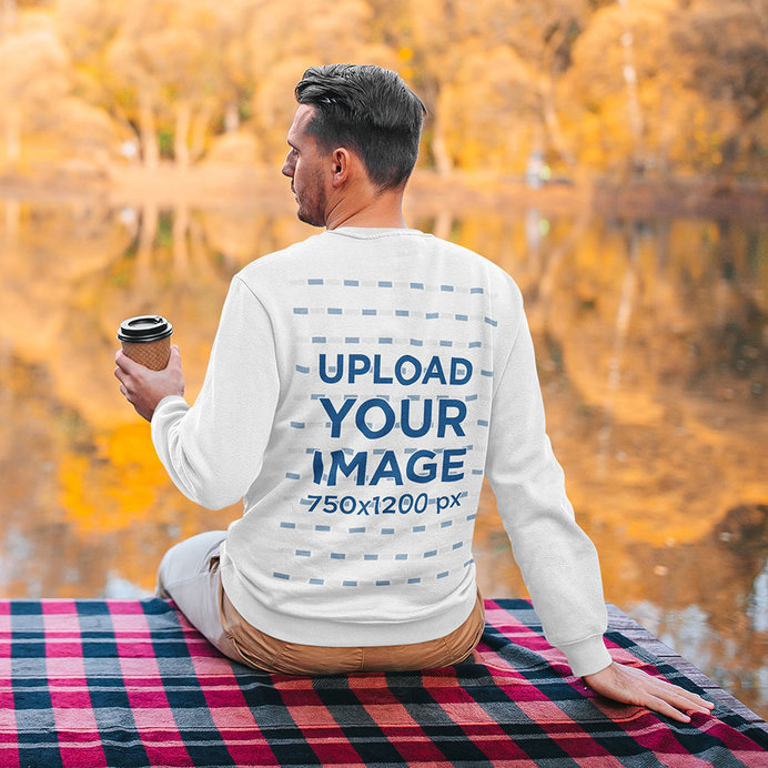 Back View Sweatshirt Mockup of a Man Sitting by a Lake 