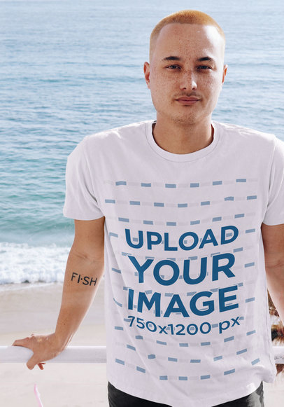 T-Shirt Mockup Featuring a Hipster Man by the Sea
