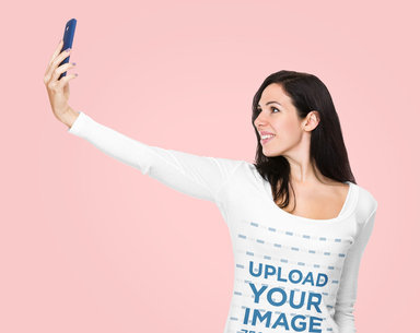 Long Sleeve Tee Mockup of a Woman Holding Her Phone Up for a Selfie