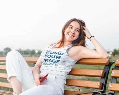 Sublimated Tank Top Mockup of a Young Woman Sitting on a Bench