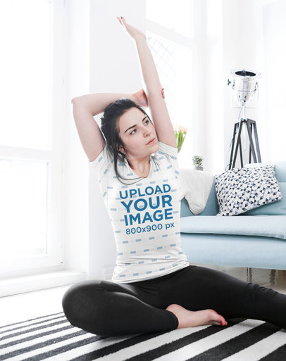T-Shirt Mockup Featuring a Female Yogi Stretching at Home m2007-r-el2
