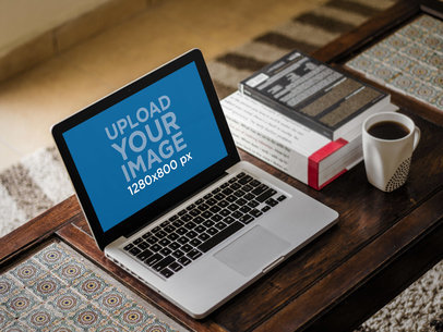 Mockup of a MacBook Pro on a Wooden Table by Some Books