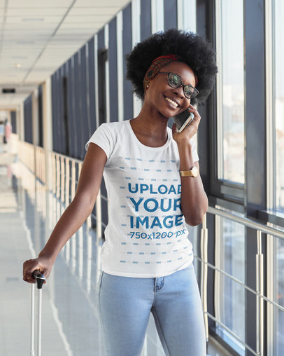 T-Shirt Mockup of a Woman Talking on the Phone While at the Airport