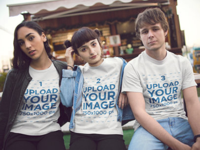 Three Young Friends Wearing Different T-Shirts Mockup Hanging Out Outdoors