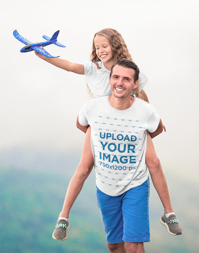 T-Shirt Mockup Featuring a Man Playing With His Daughter Outdoors