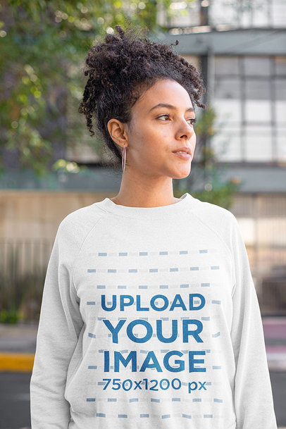 Heathered Sweatshirt Mockup of a Curly-Haired Woman Posing On the Street