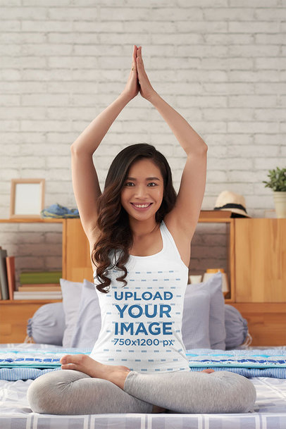 Tank Top Mockup of a Woman Doing a Yoga Pose on Her Bed