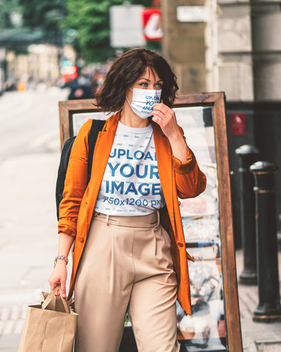 T-Shirt and Face Mask Mockup of a Stylish Woman Walking Down the Street 45429-r-el2