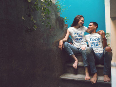 Mockup of a Young Couple Sitting on a Concrete Stairway Wearing Different T-Shirts