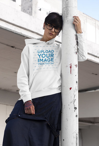 Hoodie Mockup of a Tattooed Woman Posing in an Urban Setting