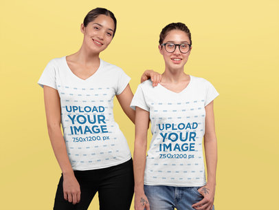V-Neck T-Shirt Mockup Featuring Two Young Women at a Studio 