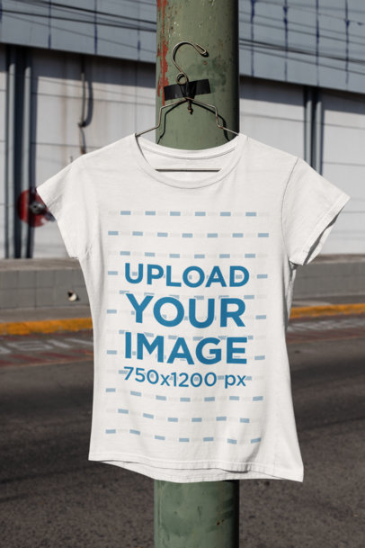 Mockup of a Basic T-Shirt  Hanging From a Light Pole 