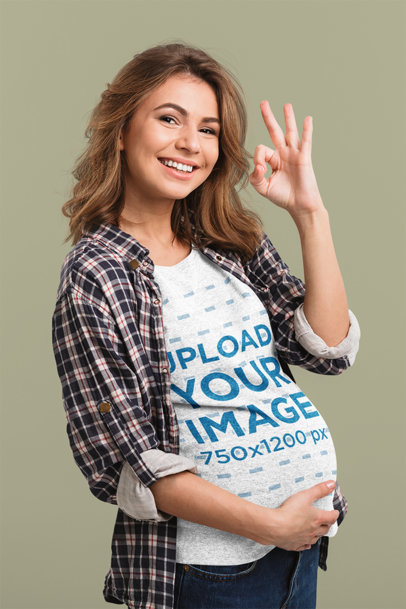 Heather T-Shirt Mockup Featuring a Happy Pregnant Woman at a Studio