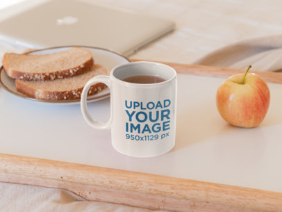 Mockup of an 11 oz Coffee Mug Featuring Bread and an Apple