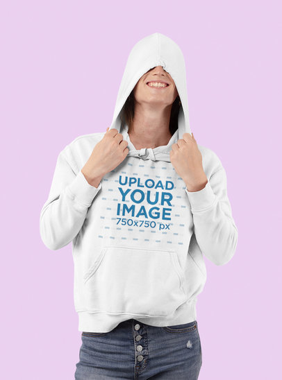 Mockup of a Happy Woman Wearing a Hoodie in a Studio