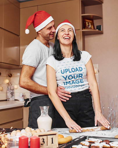 T-Shirt Mockup Featuring a Happy Woman Wearing a Christmas Hat With Her Partner While Baking m2149 r-el2