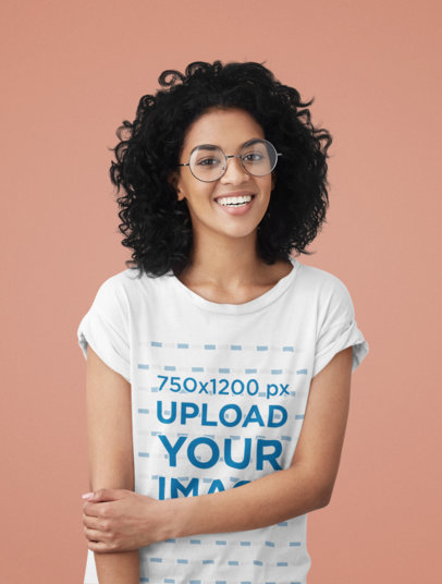T-Shirt Mockup of a Woman With Glasses Smiling in a Studio