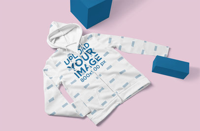 Mockup of a Sublimated Hoodie Laid Flat by Some Blocks