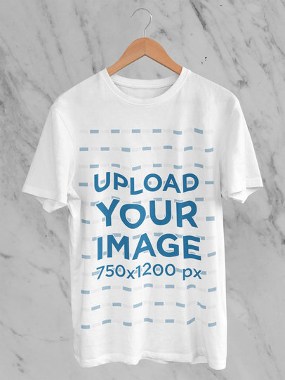 Mockup of a Round-Neck Tee Placed on a Hanger Against a Marble Wall 