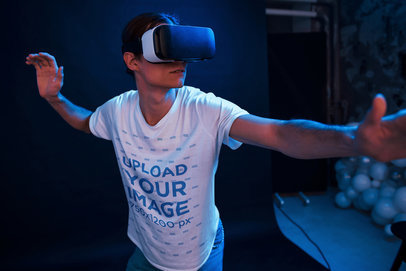 T-Shirt Mockup of a Young Man Playing with a VR in a Dark Room m1913-r-el2