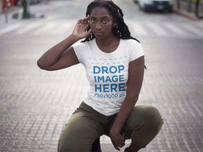 Squatting Woman Wearing a T-shirt Mockup While in the Street 15546