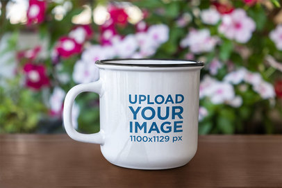 Mockup of a 12 oz Enamel Mug by a Flower Bush