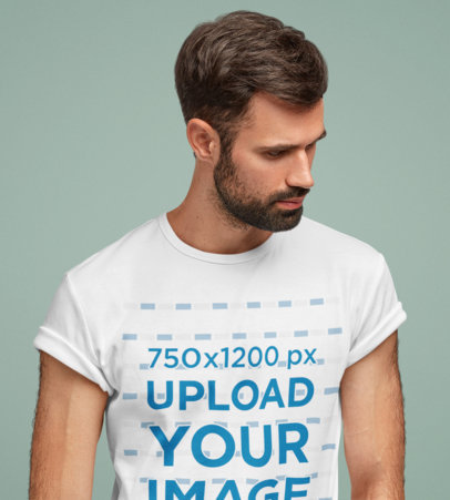 T-Shirt Mockup of a Serious Bearded Man Standing in a Studio