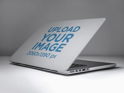 Mockup of an Angled Laptop Cover Against a Solid Color Surface