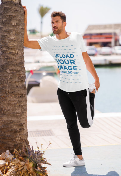 T-Shirt Mockup of a Bearded Man Preparing His Legs to Run