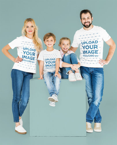 T-Shirt Mockup Featuring a Happy Family Posing Against a Colored Backdrop