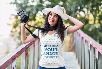 V-Neck T-Shirt Mockup of a Happy Female Photographer 