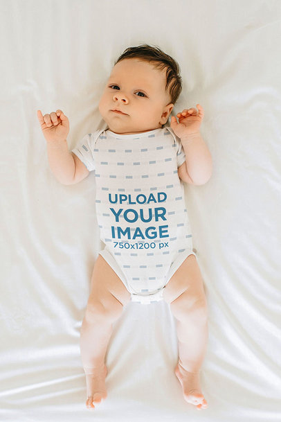 Sublimated Onesie Mockup Featuring a Baby Boy Lying On a Bed 