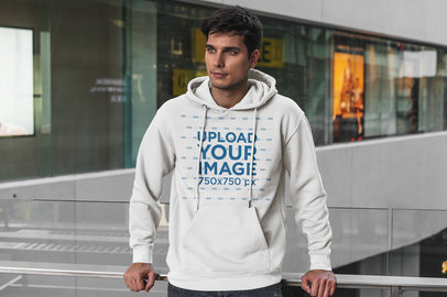 Hoodie Mockup Featuring a Serious Man Posing at a Mall 