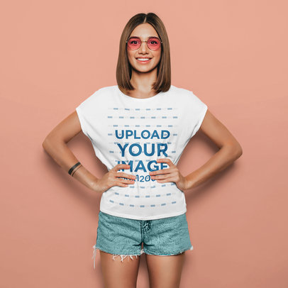 T-Shirt Mockup Featuring a Woman With an Arm Tattoo and Sunglasses at a Studio 