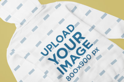 Mockup of the Back of a Sublimated Hoodie on a Colored Surface 5054-el1