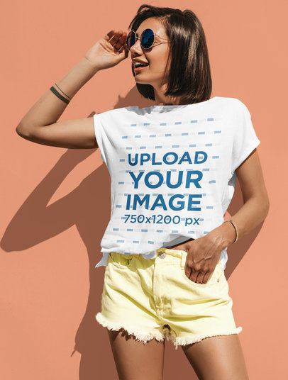 T-Shirt Mockup of a Trendy Woman Posing by a Colored Wall